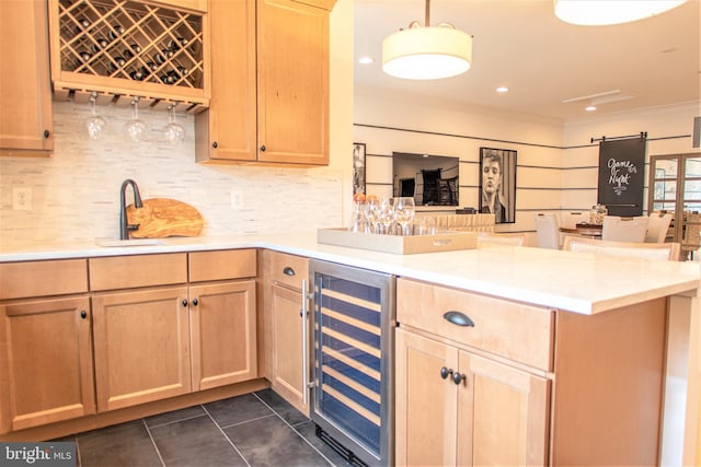 kitchen featuring decorative light fixtures, kitchen peninsula, wine cooler, tasteful backsplash, and dark tile floors