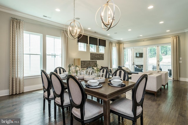 dining room featuring a notable chandelier, ornamental molding, and dark hardwood / wood-style floors