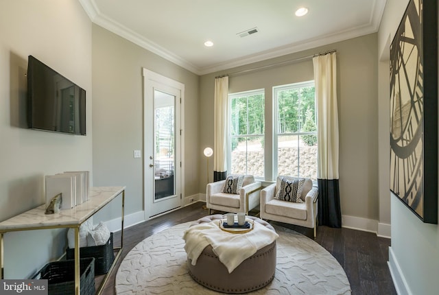 living area with ornamental molding and dark hardwood / wood-style floors