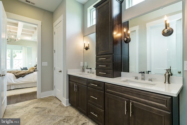 bathroom featuring double sink, an inviting chandelier, large vanity, and tile floors