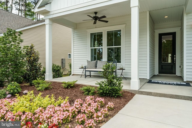 entrance to property featuring covered porch and ceiling fan