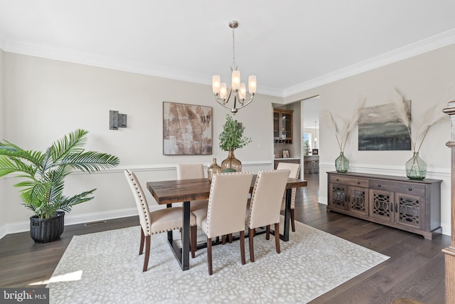 dining space featuring an inviting chandelier, crown molding, and dark wood-type flooring