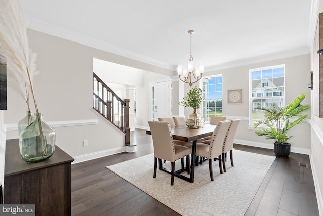 dining room with an inviting chandelier, crown molding, and dark wood-type flooring