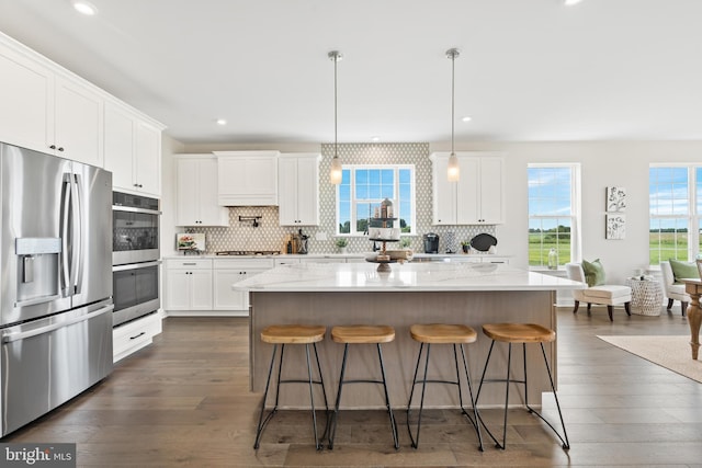 kitchen with dark hardwood / wood-style flooring, white cabinetry, and stainless steel appliances