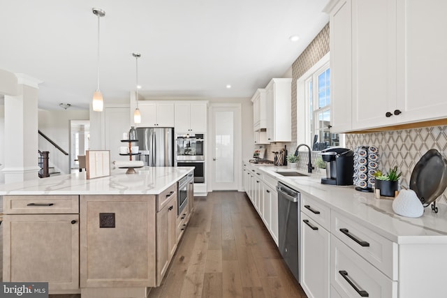 kitchen with white cabinets, light stone counters, tasteful backsplash, and stainless steel appliances