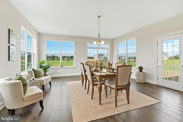 dining area featuring a notable chandelier and dark hardwood / wood-style floors