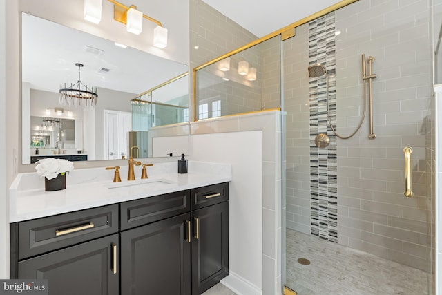 bathroom featuring an enclosed shower and vanity