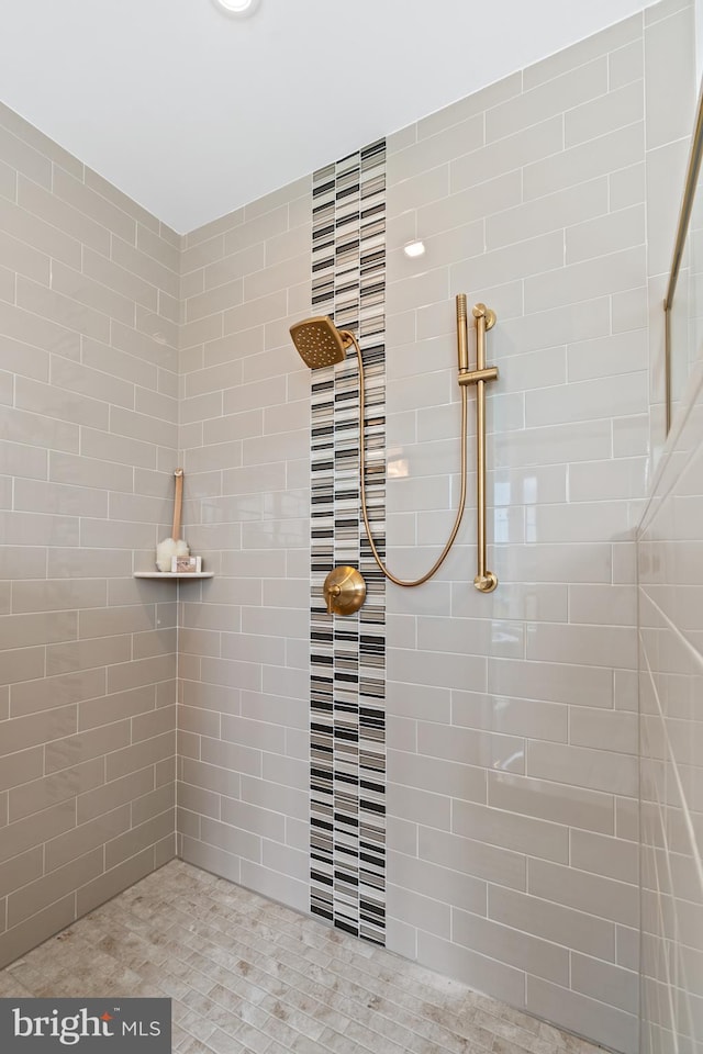 bathroom with tiled shower