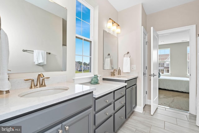 bathroom featuring double sink vanity, tile flooring, and plenty of natural light