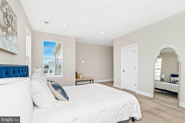 bedroom featuring light carpet