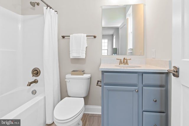 full bathroom featuring toilet, vanity, and shower / bath combo with shower curtain