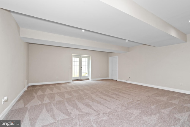 spare room with light carpet and french doors