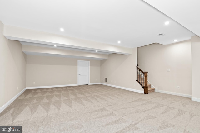 basement featuring light colored carpet