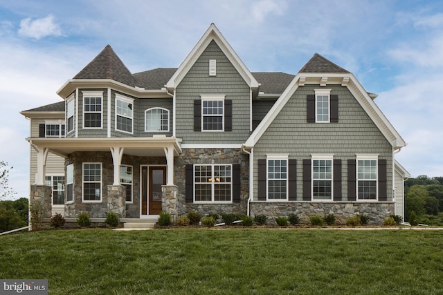 view of front of home featuring a front lawn and covered porch