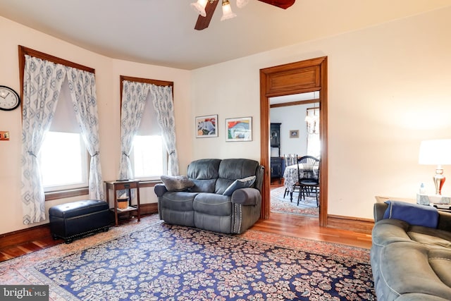 living room with ceiling fan and light hardwood / wood-style floors