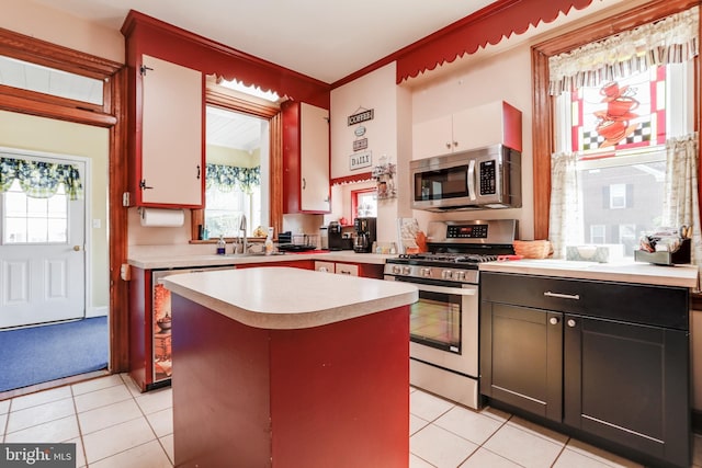 kitchen featuring light tile floors, plenty of natural light, and stainless steel appliances