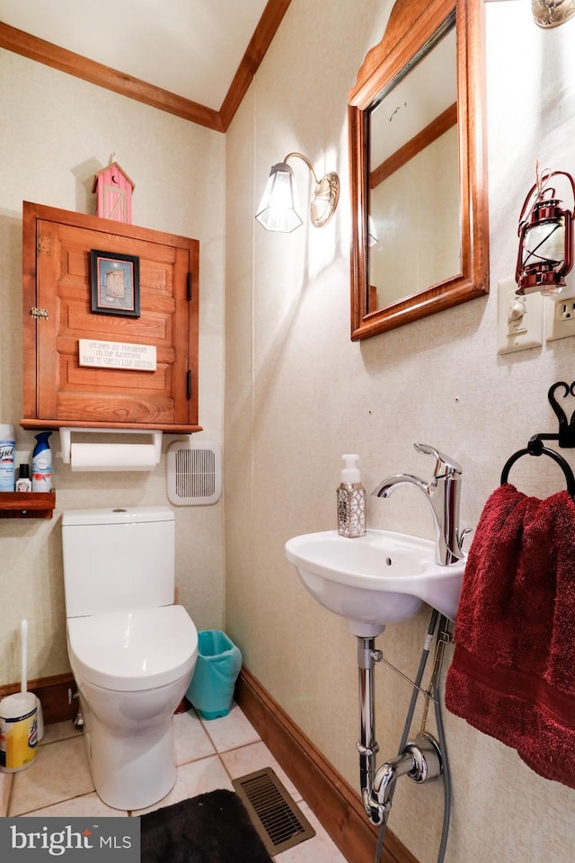 bathroom featuring sink, tile floors, toilet, and ornamental molding