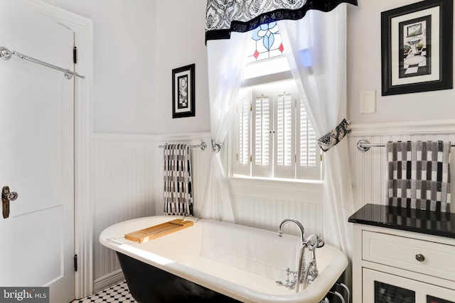 bathroom with a tub and tile flooring