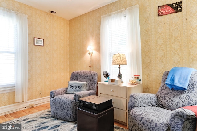 living area featuring a healthy amount of sunlight and light hardwood / wood-style flooring