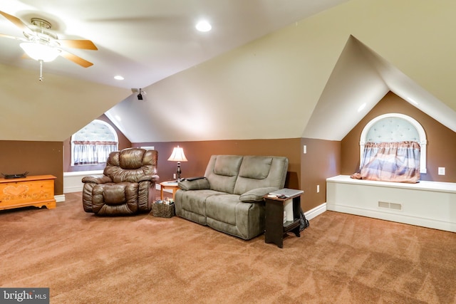 interior space with ceiling fan, light carpet, and vaulted ceiling