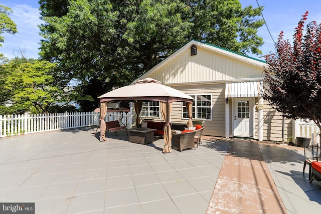 view of front facade with a gazebo, an outdoor living space, and a patio