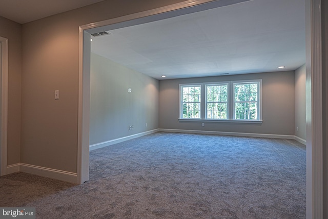 unfurnished room featuring dark carpet