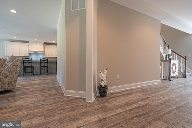 hallway featuring dark hardwood / wood-style flooring