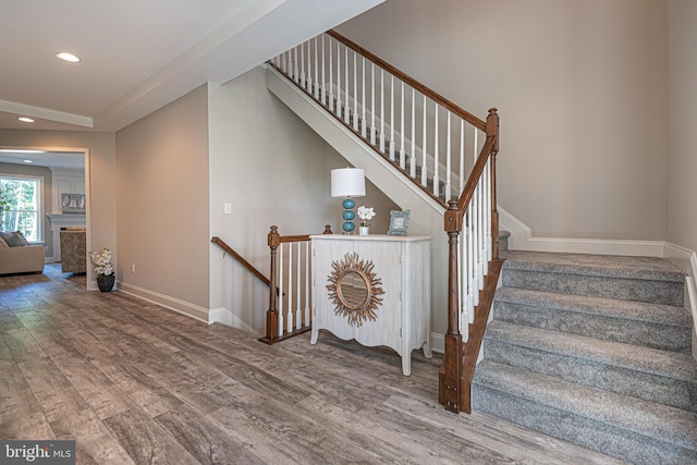 stairway with dark hardwood / wood-style floors