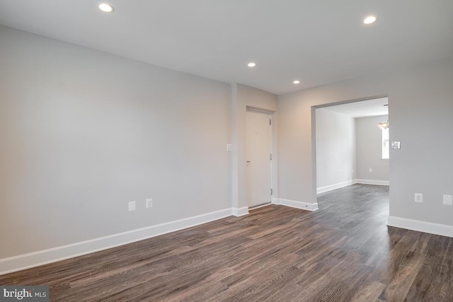 unfurnished room with dark hardwood / wood-style flooring