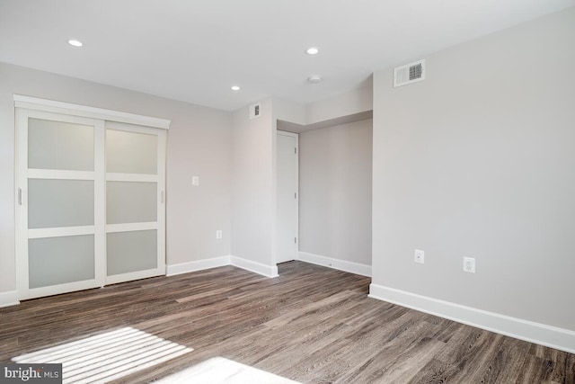 empty room with dark hardwood / wood-style floors