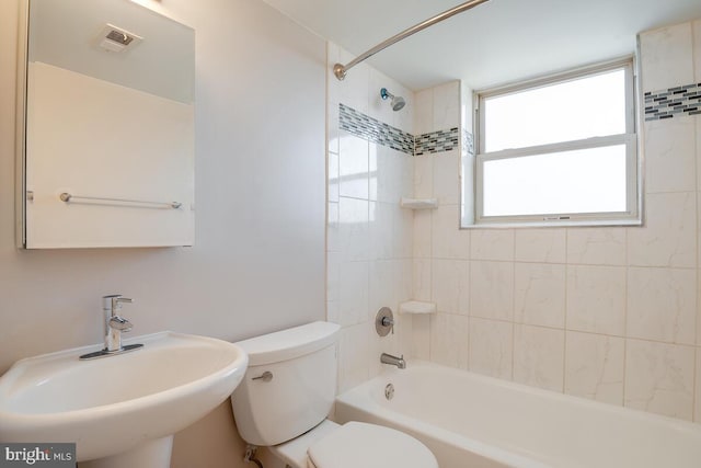 full bathroom with sink, toilet, and tiled shower / bath