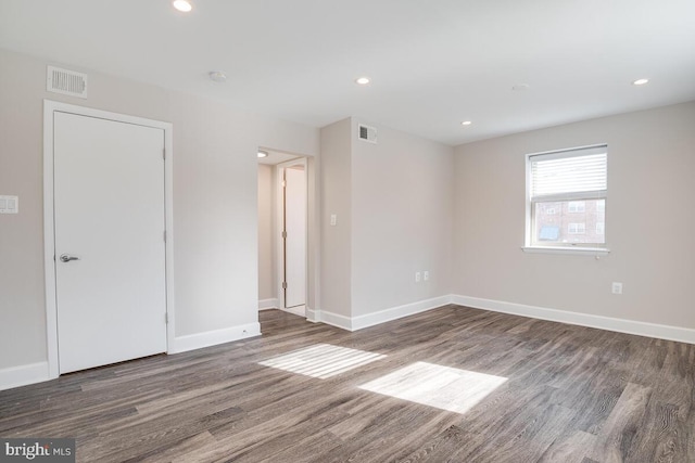 spare room featuring dark hardwood / wood-style floors