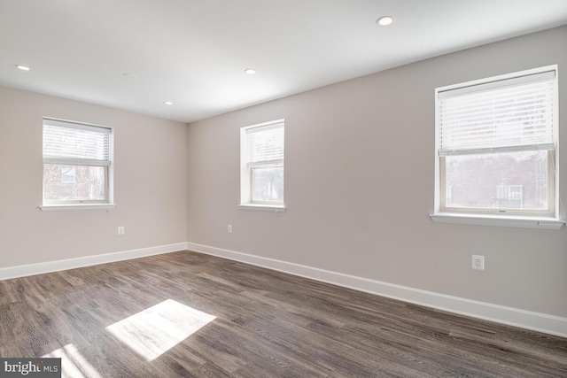 spare room with dark wood-type flooring