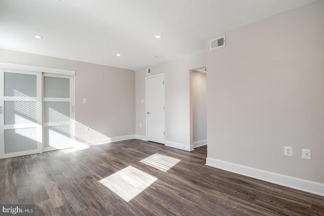 unfurnished room featuring dark wood-type flooring