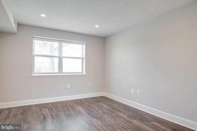 unfurnished room featuring dark hardwood / wood-style floors