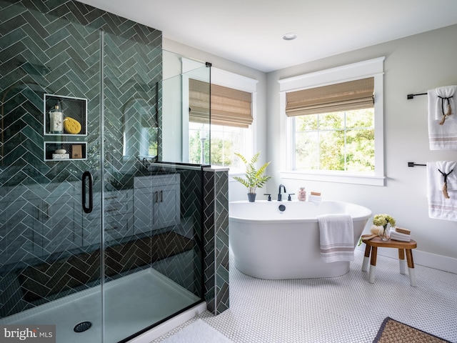 bathroom with independent shower and bath and tile patterned floors