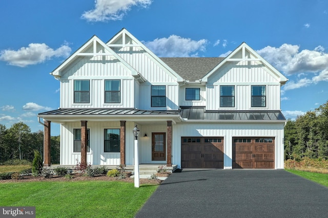 modern farmhouse style home featuring a porch, a front yard, and a garage