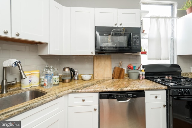 kitchen featuring tasteful backsplash, white cabinets, and black appliances