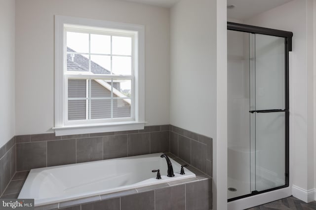 bathroom featuring separate shower and tub