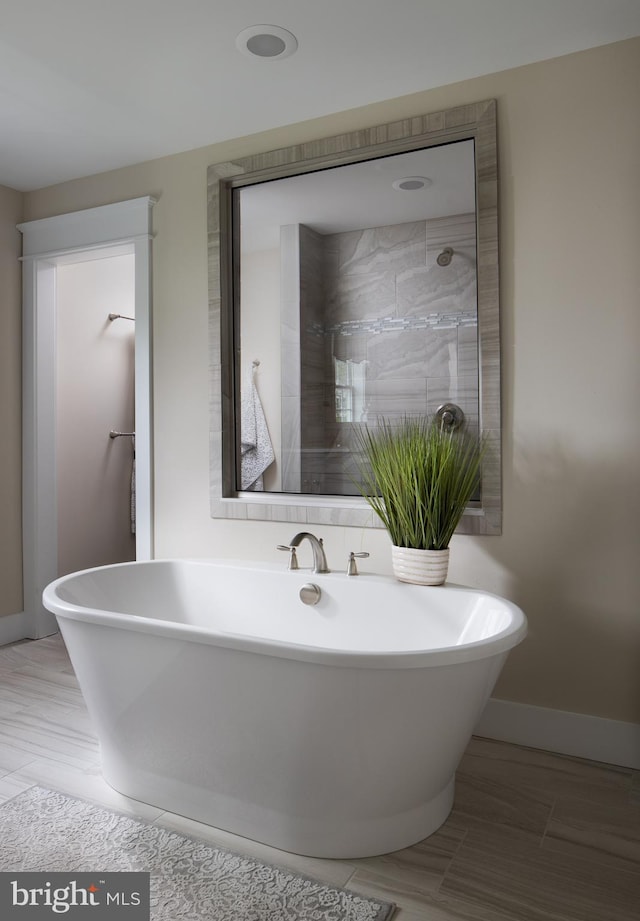 bathroom featuring separate shower and tub