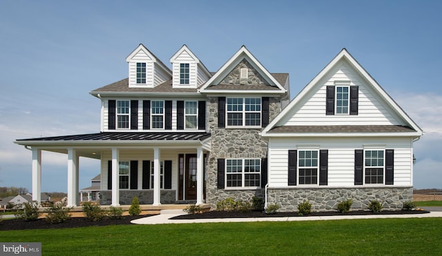 view of front of property with a porch and a front lawn