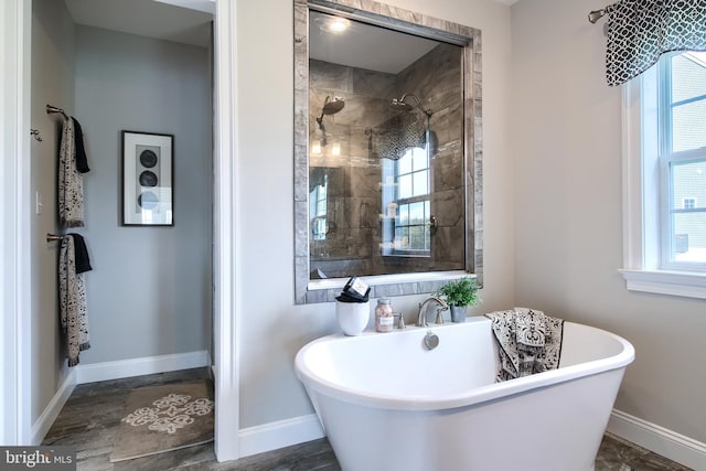 bathroom featuring plus walk in shower and a healthy amount of sunlight