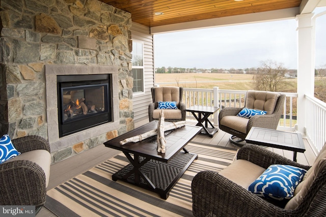 view of patio / terrace with a rural view and an outdoor stone fireplace