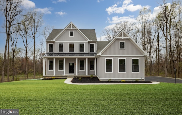 craftsman inspired home featuring covered porch and a front yard