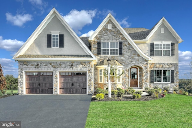 view of front of property with a garage and a front lawn