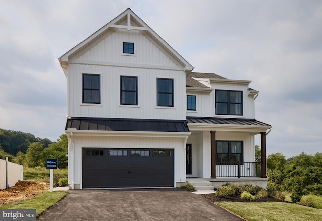 modern farmhouse style home with a porch and a garage