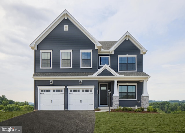 view of front of home featuring a garage and a front yard