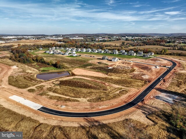 birds eye view of property with a rural view