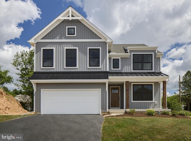 view of front of property featuring a front yard and a garage