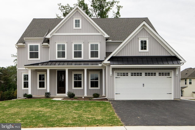 view of front facade with a porch, a garage, and a front yard